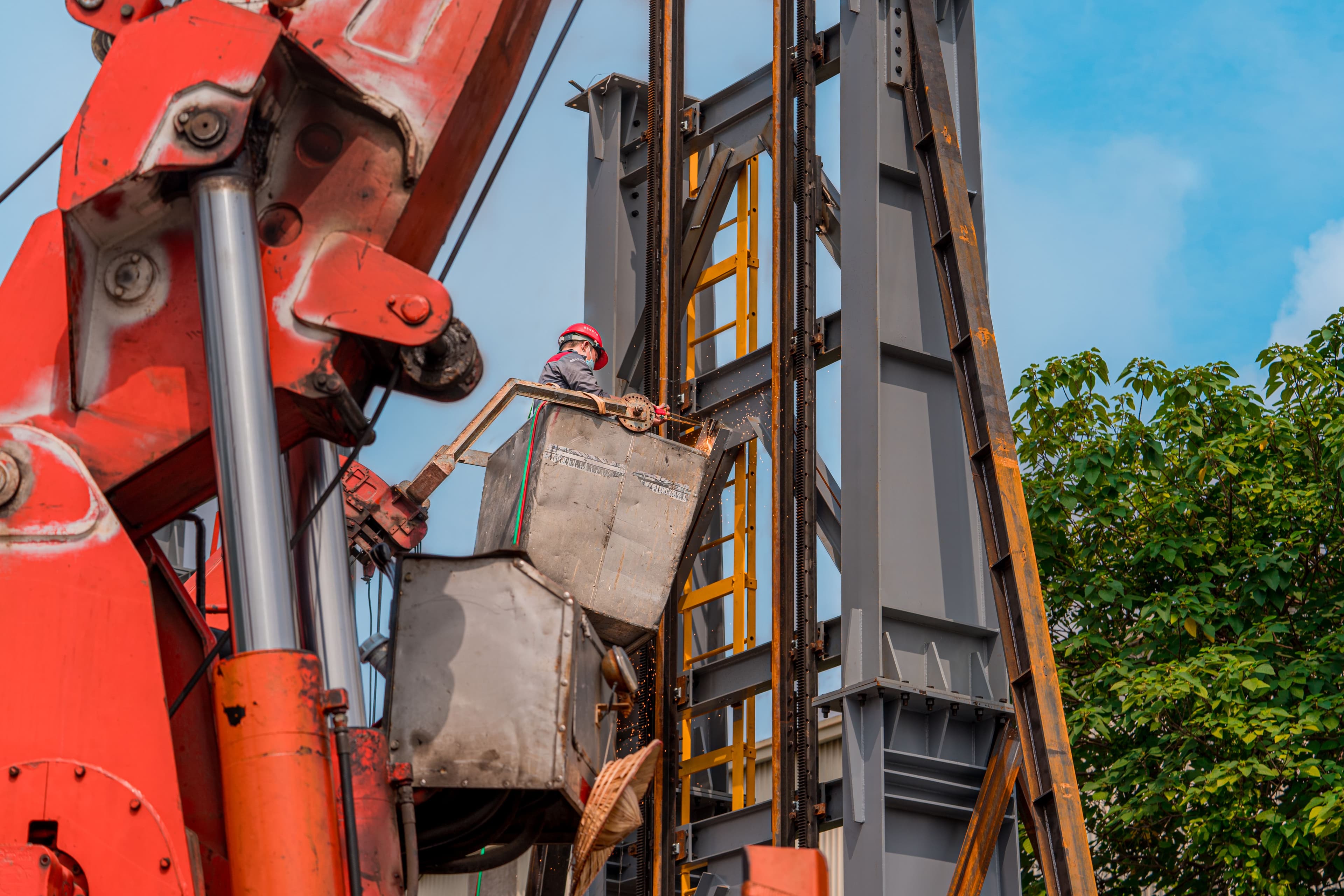 Heavy lifting machine working beside a steel structure